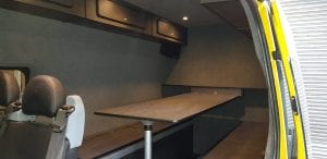 Transit van converted into camper van with beds and table