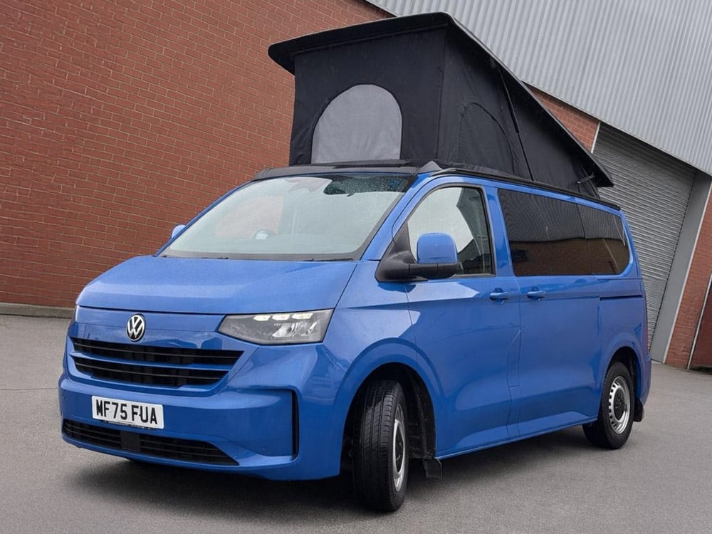 Blue campervan conversion package with pop top roof raised
