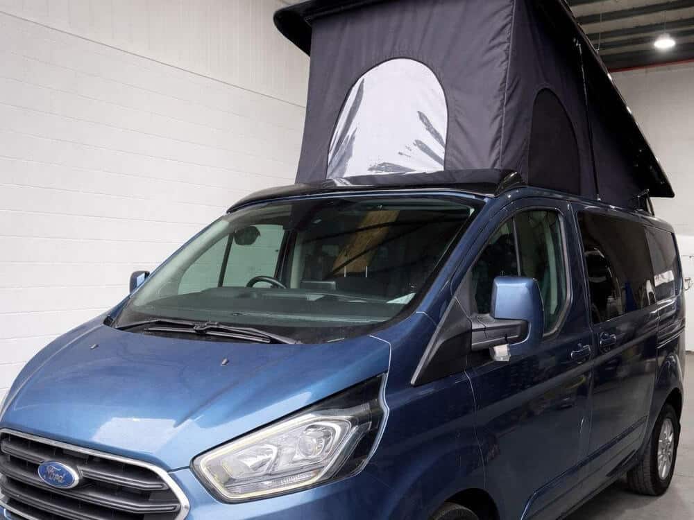 Blue Ford campervan conversion with pop top roof