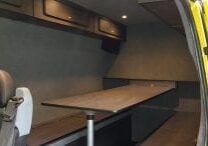 Transit van converted into camper van with beds and table